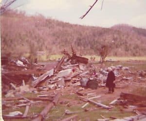 Woman standing amidst the rubble of the damage from the Dowelltown tornado 50 years ago