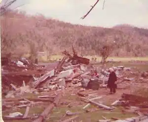 Woman standing amidst the rubble of the damage from the Dowelltown tornado 50 years ago