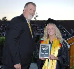 DCHS Principal Bruce Curtis presents Citizenship Award to Brynn Harvey during Class of 2024 Graduation Friday night