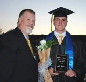 DCHS Principal Bruce Curtis presents White Rose Award to Luke Magness during Class of 2024 Graduation Friday night
