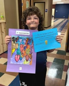 Naziah Martinez from the 1st to 2nd grade Division captured the “People’s Choice Award” in the DeKalb Schools Art Exhibit held Saturday at the County Complex. Naziah and the winning entry are shown here