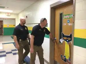 Sergeant Will Judkins of the Smithville Police Department (left) and Detective Chris Russell of the DeKalb County Sheriff’s Department (right)were among local officers roaming the halls checking interior doors Monday at Northside and Smithville Elementary Schools during school lock down intruder drills