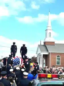 Following the funeral service Wednesday afternoon at the First Baptist Church Life Enrichment Center, DeKalb EMS Director and Deputy Smithville Fire Chief Hoyte Hale’s flag draped coffin was carried by fellow Smithville firefighters and EMS co-workers and then placed aboard a fire truck before being taken along the route to the cemetery with full firefighter honors.