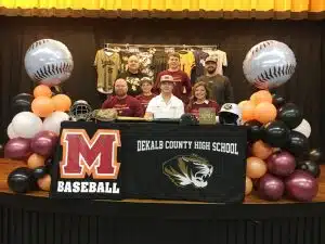 DCHS baseball senior Ty Webb signed with Maryville College at DCHS. Pictured here left to right seated: DCHS Baseball Coach and Ty’s father Tad Webb, brother Tate, Ty Webb, and mother Tracy Webb. Standing left to right: Assistant Coach David Parker, brother Tucker Webb, and Assistant Coach Daniel Leslie
