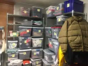 Totes of clothes in various sizes for the homeless