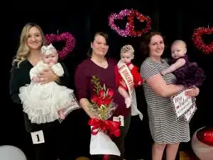 The winner of the Valentine Pageant Saturday (age 1 day to 6-month division) was Queen Stella Clouse of Smithville (center), 6-month-old daughter of Amanda Clouse and Drake Clouse. She was awarded for prettiest eyes. Runners-up were 1st- Eliza Beth Burke of Smithville (left), 4-month-old daughter of Jonah and Kelsey Burke. Second runner-up was Iris Jane Grigg of Gordonsville (right), 5-month-old daughter of Paige and Ian Grigg. She received honors for prettiest hair, attire, and smile.