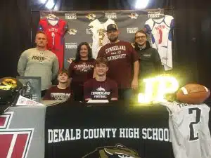 Senior Jordan Parker, the 2024 DCHS Tiger Football Most Valuable Player, has announced his next move now that his high school pigskin playing days are over. Joined by members of his family, coaches, and teammates Monday at DCHS, Parker celebrated his signing last week to join the Phoenix at Cumberland University at Lebanon after he graduates in May. Pictured: left to right- seated Auston Parker and Jordan Parker. Standing left to right-Tiger Coach Steve Trapp, Dallas Parker, Kendall Parker, and Bryson Stewart