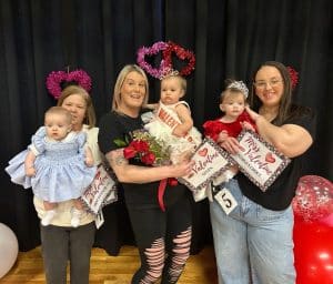 Winning the Valentine Pageant category Saturday (7 to 12 months) was queen Willow Rose Sullivan of Doyle (center) the 12-month-old daughter of Kayla and Travis Sullivan. She received honors for prettiest eyes and smile. Runners-up were 1st- Charlotte Cay Koelle of Smithville (left) 8-month-old daughter of Christian and Heather Koelle. She also took home awards for prettiest hair, attire, and most photogenic. Second runner-up was Halle Grace Karolyn Underhill of Smithville (right) 11-month-old daughter of Nick and Christian Underhill. She received the people’s choice award.
