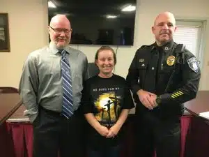 Alexandria Mayor Beth Tripp congratulates Interim Police Chief Vincent Turocy (right) after his being named full time chief by a majority of the aldermen Monday night, April 7. Also by a majority vote, the aldermen hired Nathaniel (Nate) Lombard (left) as a full time officer