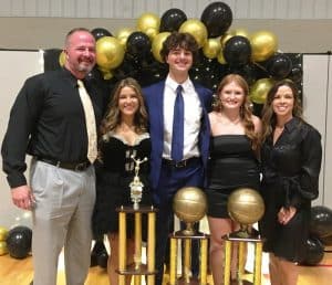 Seniors Dallas Kirby and Avery Agee were named the DCHS Tiger and Lady Tiger basketball Most Valuable Players Saturday night at the annual team banquet, while Senior Annabella Dakas is the Most Valuable Cheerleader. The awards were sponsored by Love-Cantrell Funeral Home and presented by Chad and Shelia Kirby. The MVP and MVC awards are named in memory of Kirby’s grandfather Allen D. Hooper. Dallas Kirby is the son of Chad and Shelia and the great grandson of Allen Hooper. The awards are voted on by the coaches. Pictured left to right: Chad Kirby, Annabella Dakas, Dallas Kirby, Avery Agee, and Shelia Kirby