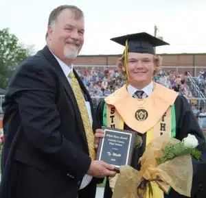 DCHS Principal Bruce Curtis presents White Rose Award to Ty Webb during Class of 2025 Graduation Friday night