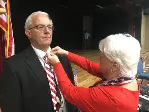 Gentiva Hospice acknowledged veterans and family members in attendance during Monday’s Memorial Day observance and presented pins to each. Photo shows Patsy Turner pinning husband John Turner, a veteran