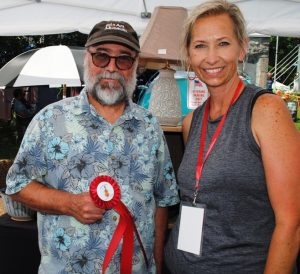 Fiddlers Jamboree Craft Director Judith Hale presents “Best Appalachian Craft” Award to Timothy Weber of Kingston Springs. He displayed handcrafted pottery products