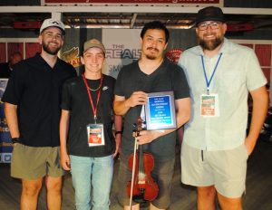 Contest Fiddle (Neil Dudney Memorial Award)-sponsored by the Dudney Family: First Place- Tyler Andal of Nashville. The Neil Dudney Award was presented to Andal by two of Dudney’s grandchildren, Ethan and Brandon Shaw and great grandson Carson Shaw. Dudney, who passed away in October 2018 served as President and Coordinator of the Fiddlers Jamboree for 16 years until he stepped down in 2008.