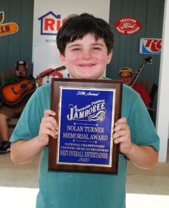 Kade Stewart of Anderson, Alabama was winner of the Nolan Turner Memorial Entertainer of the Year award. The honor, sponsored by the Turner family, is presented to the best overall instrumental entertainer among winners in the Fiddlers Jamboree Beginner dobro guitar, mandolin, five string banjo, and flat top guitar competition. Stewart earned first place in the beginner dobro guitar contest; took second place in the beginner five string banjo and flat top guitar events; and earned third place in beginner mandolin.