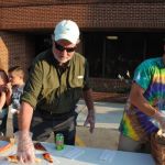 School Board Chairman W.J. (Dub) Evins III and Director of Schools Patrick Cripps preparing to serve up pizza at Education Celebration